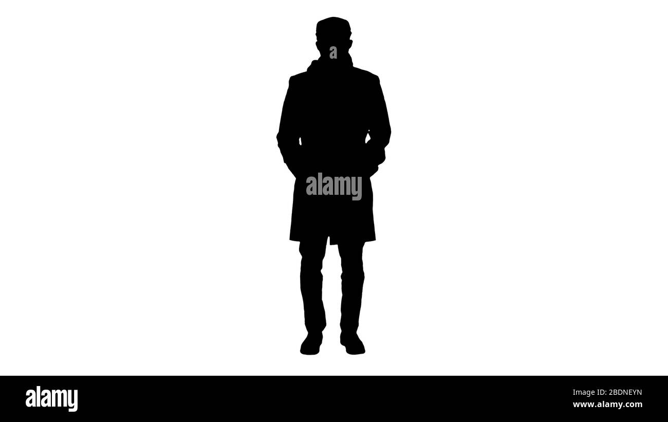 Silhouette uomo in stile inglese in un cappotto con maschera di protezione l Foto Stock