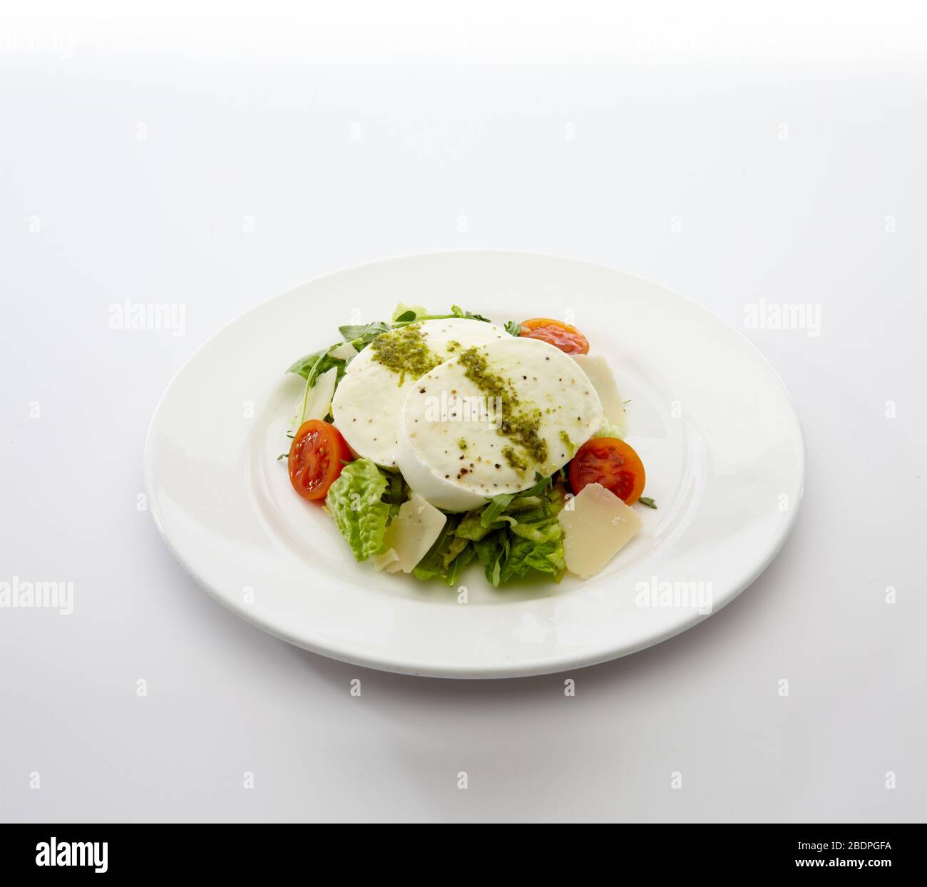 Piatto di mozzarella di bufala con insalata estiva da giardino su sfondo bianco Foto Stock