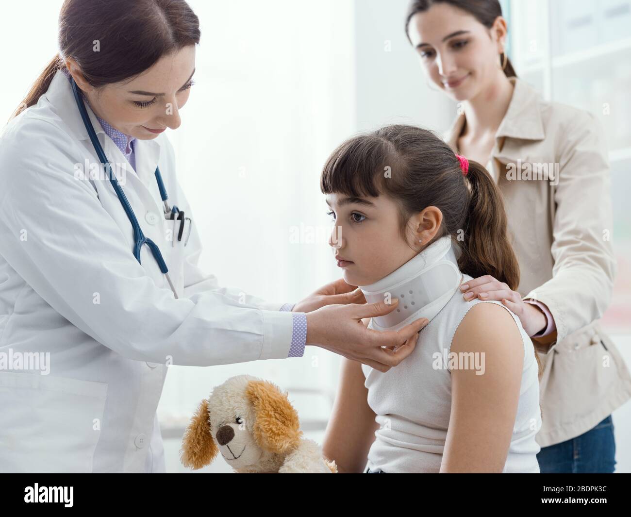Medico in visita ad una giovane ragazza con collare cervicale