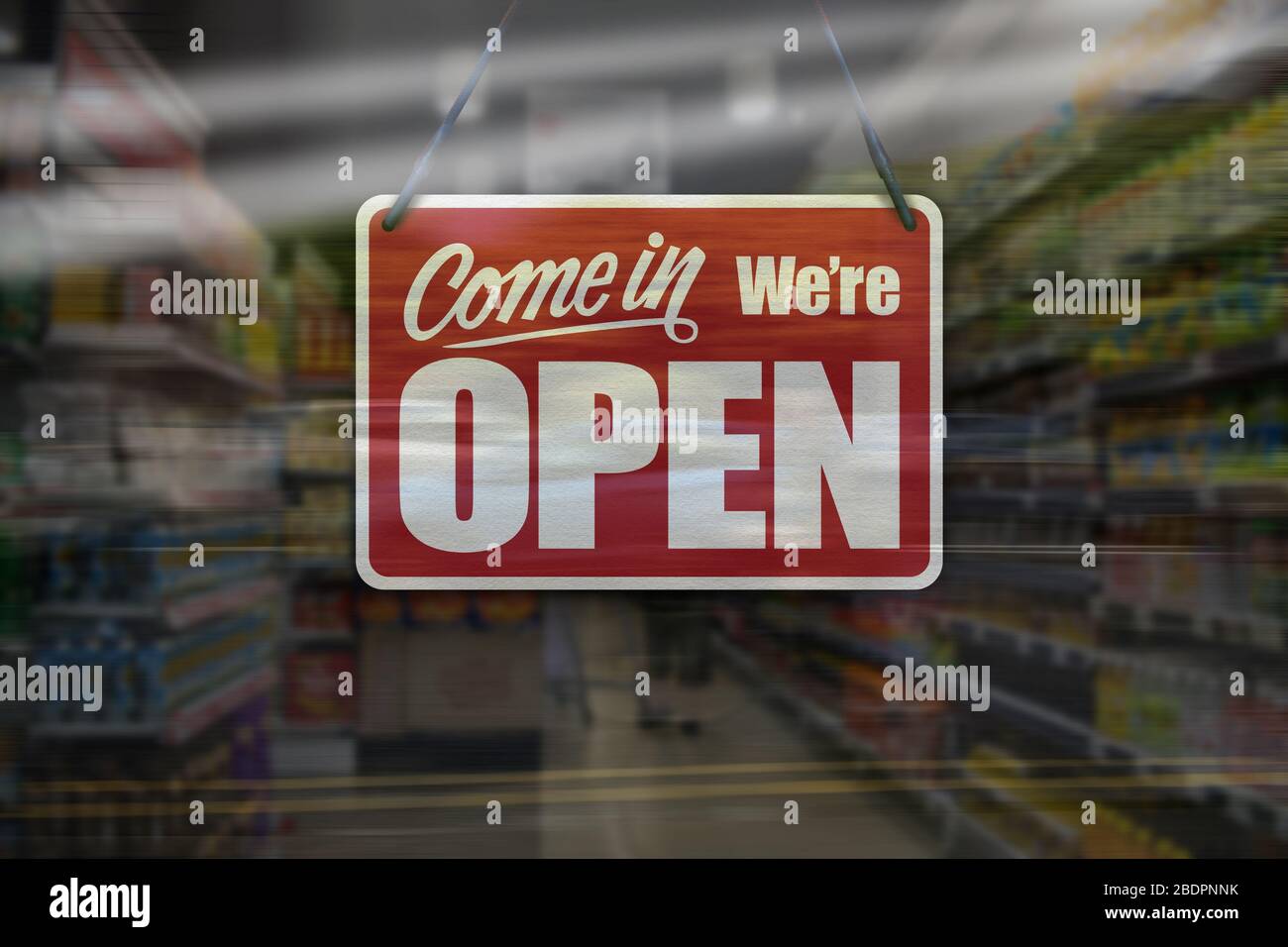 Un segno di affari che dice 'come in We're Open' sul supermercato o la finestra del minimarket. Foto Stock