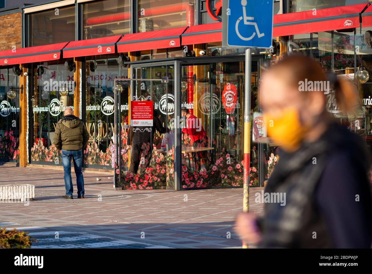 I clienti che aspettano e portano via o ritirano i loro ordini dal ristorante Happy Bar & Grill di Sofia, Bulgaria, Europa orientale, Balcani, UE Foto Stock