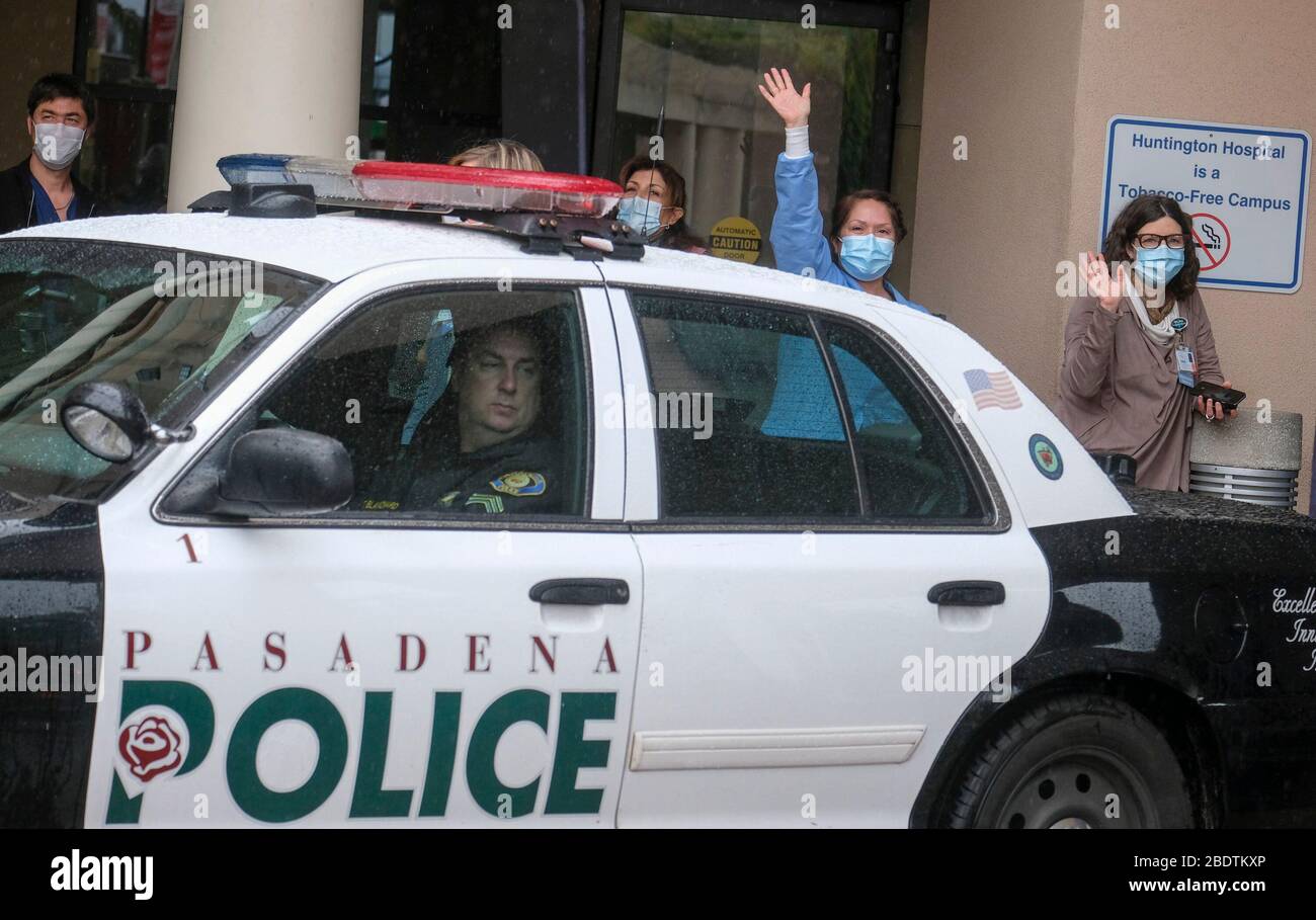 Los Angeles, California, Stati Uniti. 9 Aprile 2020. Gli operatori sanitari salutano mentre la polizia e il personale dei vigili del fuoco di Pasadena si accingeranno davanti all'Huntington Hospital con luci di emergenza e sirene attivate per mostrare apprezzamento agli operatori sanitari nella sala d'emergenza e in tutto l'ospedale di Pasadena, California, giovedì 9 aprile 2020. Credit: Ringo Chiu/ZUMA Wire/Alamy Live News Foto Stock