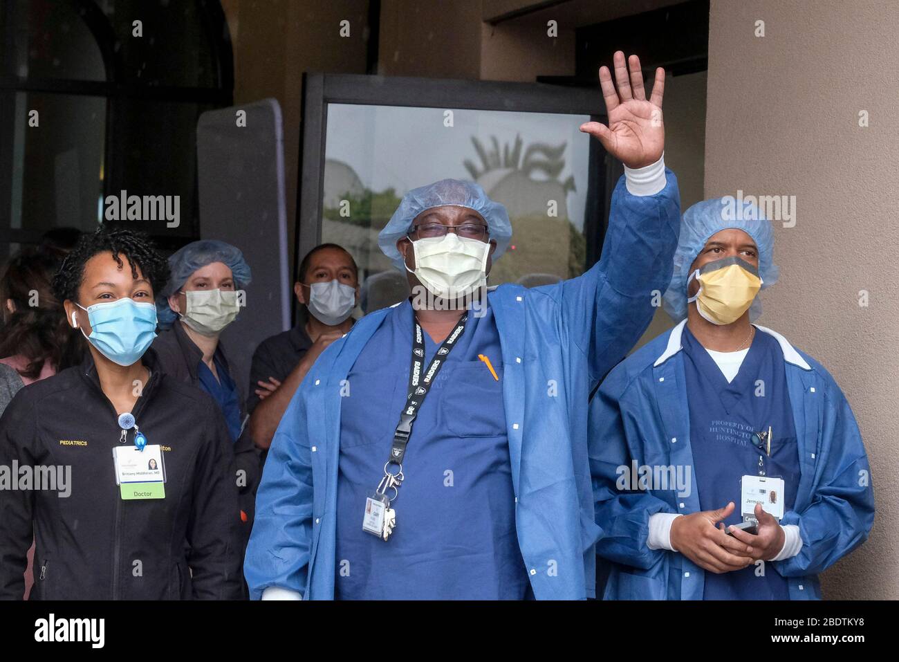 Los Angeles, California, Stati Uniti. 9 Aprile 2020. Gli operatori sanitari salutano mentre la polizia e il personale dei vigili del fuoco di Pasadena si accingeranno davanti all'Huntington Hospital con luci di emergenza e sirene attivate per mostrare apprezzamento agli operatori sanitari nella sala d'emergenza e in tutto l'ospedale di Pasadena, California, giovedì 9 aprile 2020. Credit: Ringo Chiu/ZUMA Wire/Alamy Live News Foto Stock