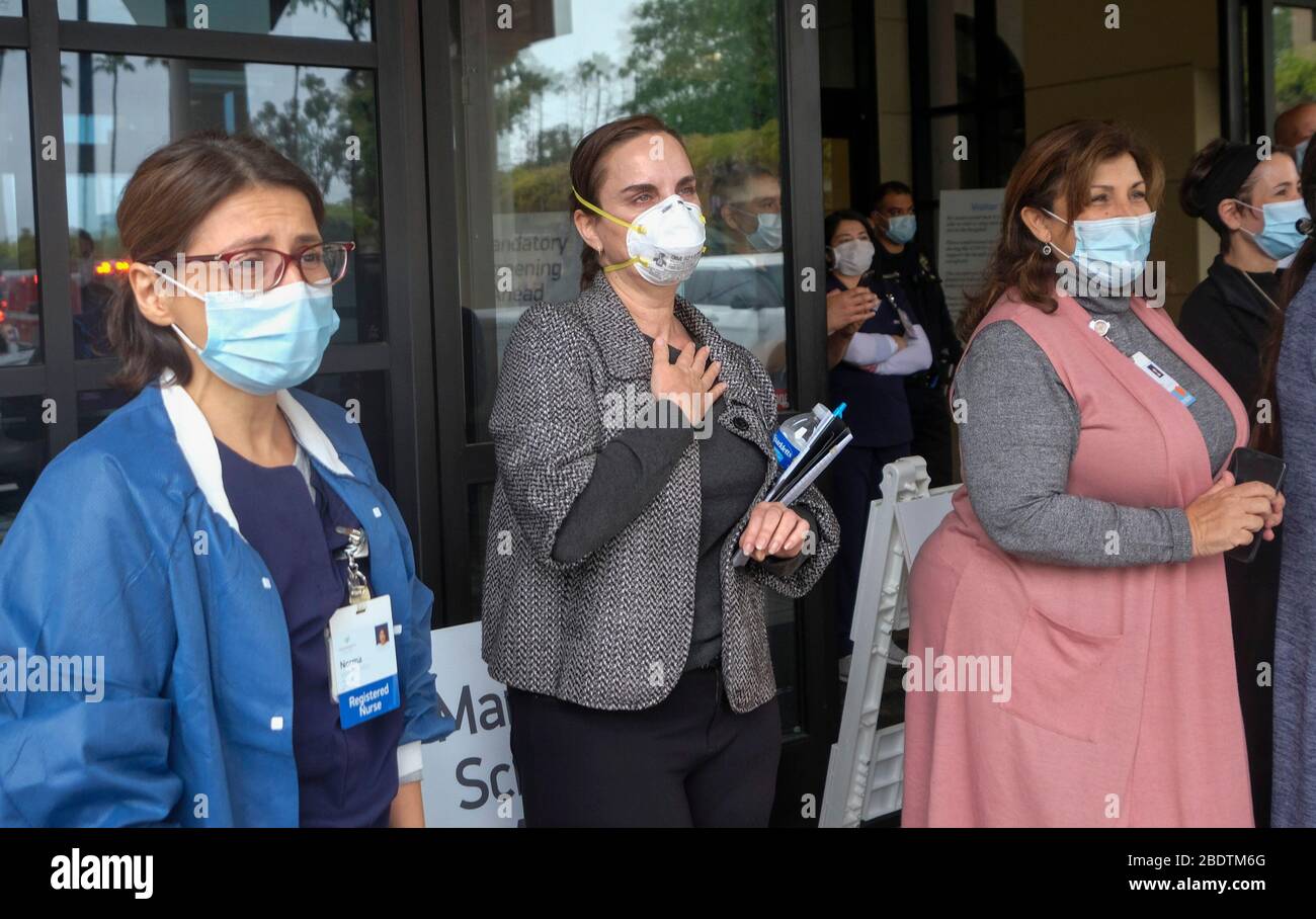 Los Angeles, California, Stati Uniti. 9 Aprile 2020. Gli operatori sanitari salutano mentre la polizia e il personale dei vigili del fuoco di Pasadena si accingeranno davanti all'Huntington Hospital con luci di emergenza e sirene attivate per mostrare apprezzamento agli operatori sanitari nella sala d'emergenza e in tutto l'ospedale di Pasadena, California, giovedì 9 aprile 2020. Credit: Ringo Chiu/ZUMA Wire/Alamy Live News Foto Stock