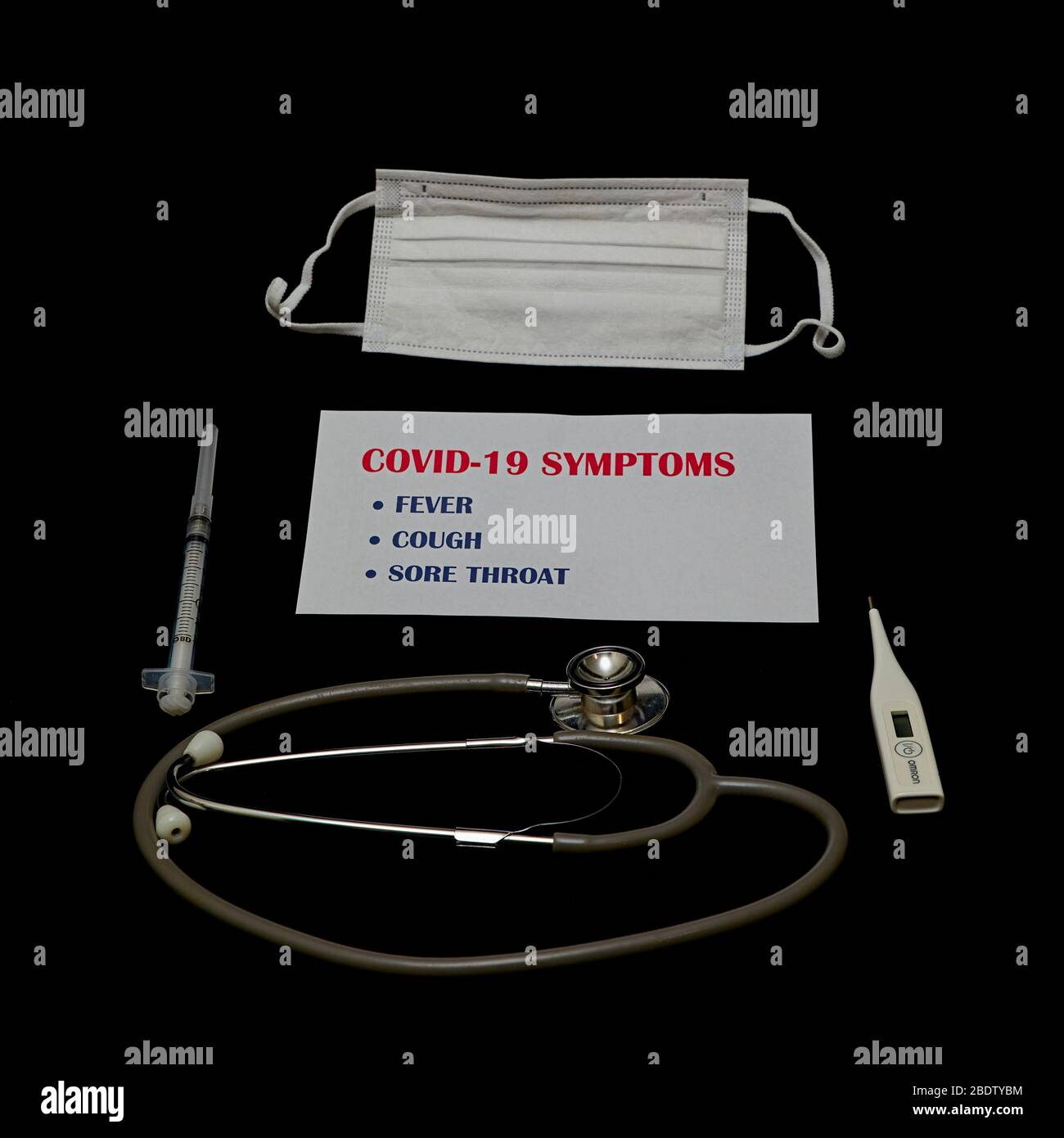 Covid-19 sintomi, maschera chirurgica e stetoscopio - uno strumento medico per ascoltare l'azione di qualcuno cuore o di respirazione, tipicamente avere Foto Stock