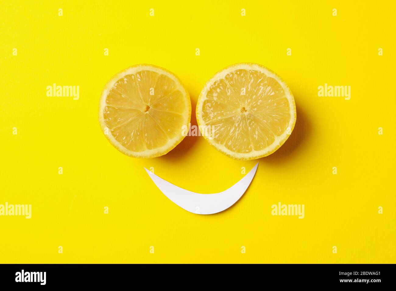 Faccina sorridente di limoni su sfondo giallo Foto Stock