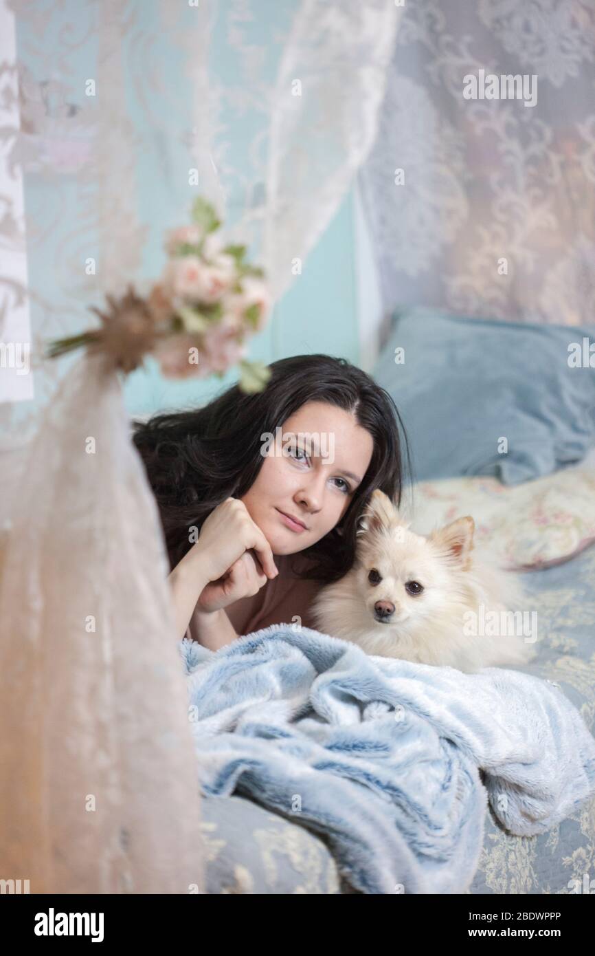 Giovane ragazza beautifil con il suo cane dolce piccolo a casa Foto Stock