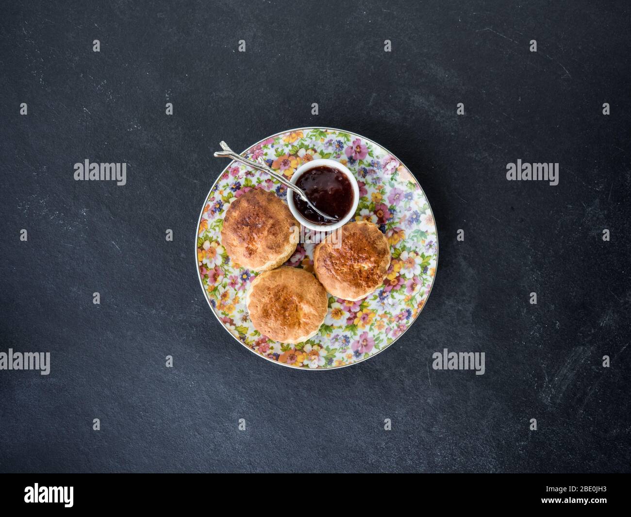 Focaccine fatte in casa appena sfornate con marmellata, sfondo di ardesia, vista dall'alto Foto Stock