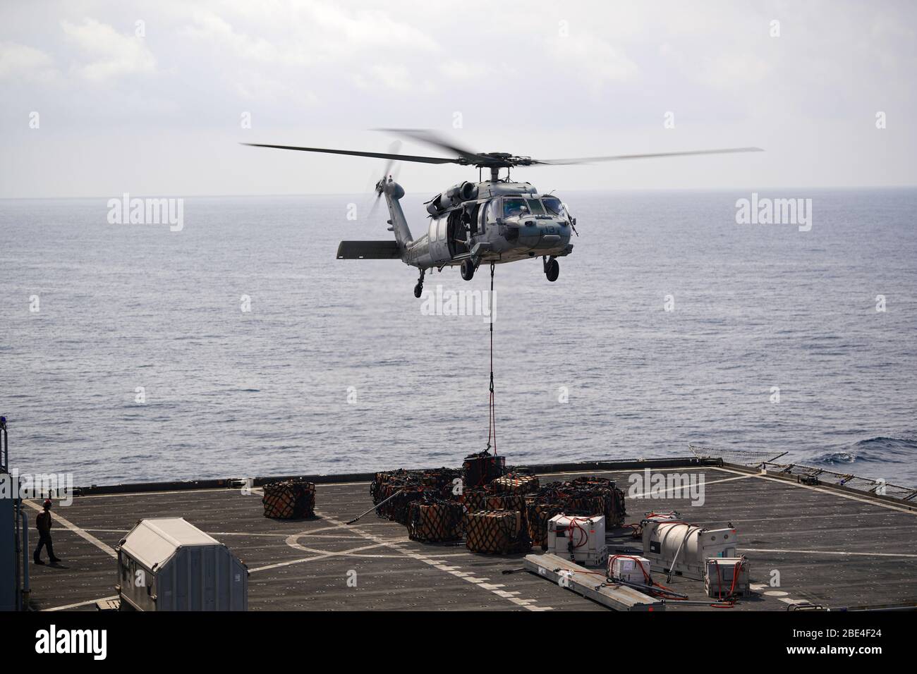 200401-N-FS718-1028 ARABIAN SEA (1 aprile 2020) un MH-60S Seahawk attaccato ai 'Dogs sty' di elicottero Sea Combat Squadron 7 sposta le forniture dalla USNS Robert E. Peary (T-AKE-5) durante un rifornimento verticale con la portaerei USS Dwight D. Eisenhower (CVN 69) 1 aprile 2020. IKE è distribuito nell'area operativa della 5th Fleet statunitense a sostegno delle operazioni navali per garantire stabilità e sicurezza marittima nella regione centrale, collegando il Mediterraneo e il Pacifico attraverso l'Oceano Indiano occidentale e tre punti di strozzatura strategici. (STATI UNITI Foto Navy di Aircrew Survival equipe Foto Stock