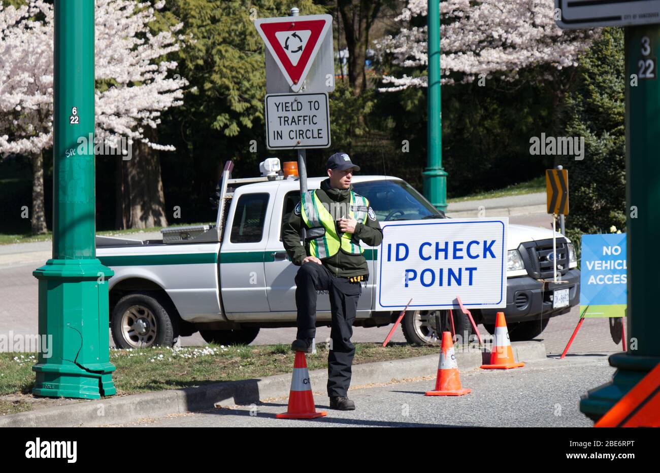 Vancouver, Canada - Aprile 11,2020: Il Vancouver Park Ranger si trova vicino al punto di controllo ID nello Stanley Park. Non è consentito l'uso di veicoli in Stanley Park a causa di Foto Stock