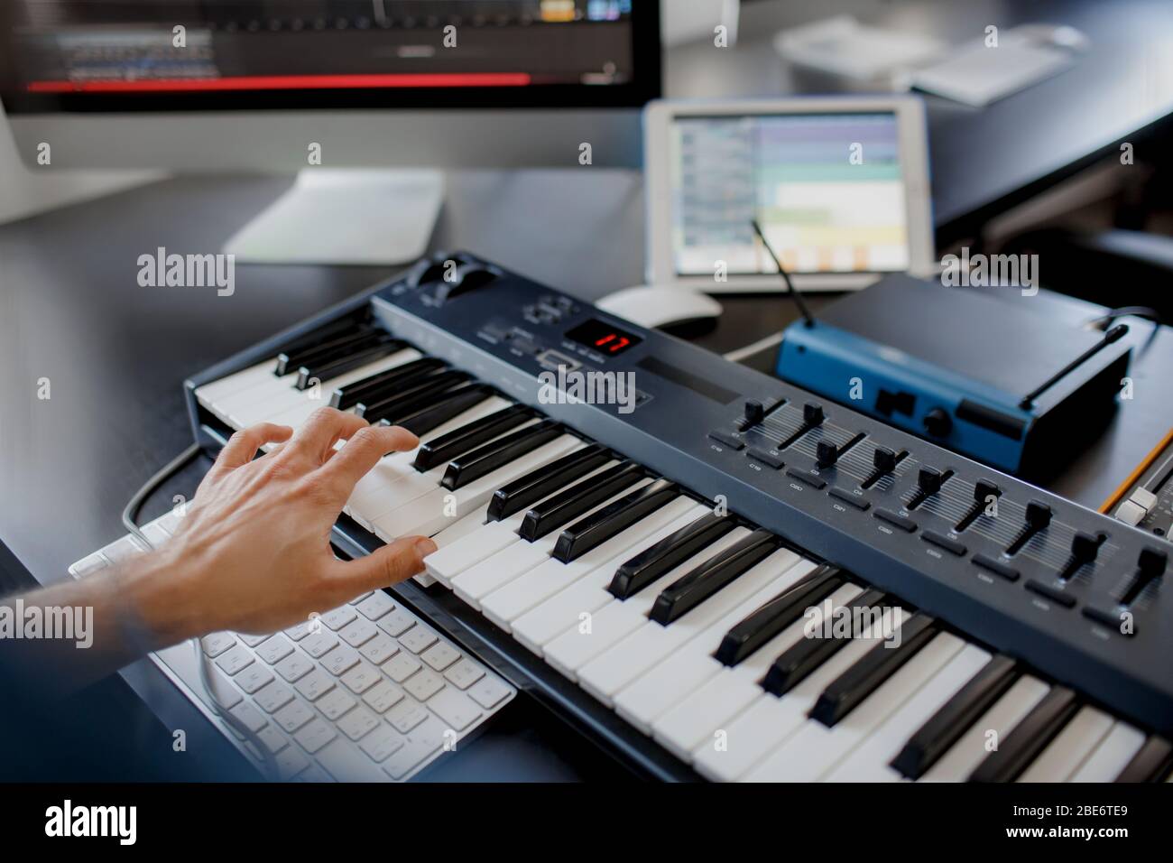 compositore ha a disposizione i tasti del pianoforte nello studio di  registrazione. tecnologia di produzione musicale,