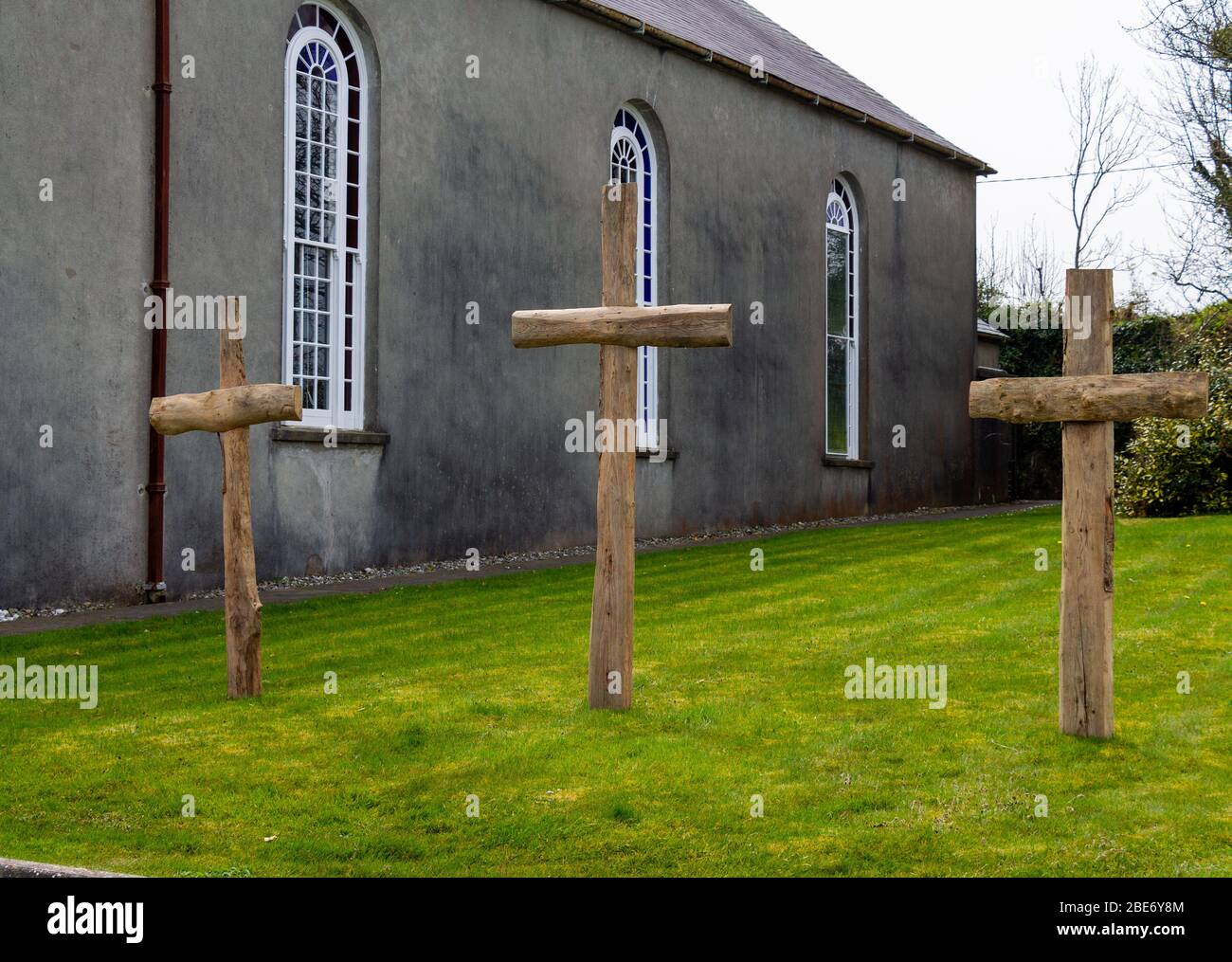 3 croci di legno fuori da una chiesa di un granaio irlandese Foto Stock