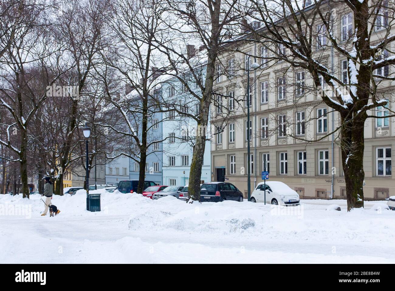 Coperte di neve un parco di fronte a storiche case a schiera in una parte ricca di Oslo centrale, Norvegia. Foto Stock