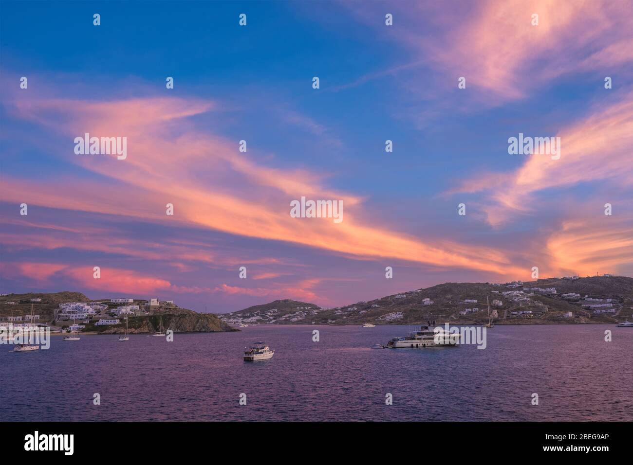 Tramonto a Mykonos, Grecia e yacht nel porto Foto Stock