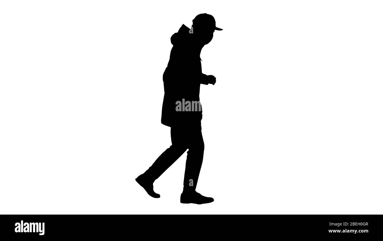 Silhouette giovane uomo in abiti da esterno e maschera medica jogging Foto Stock