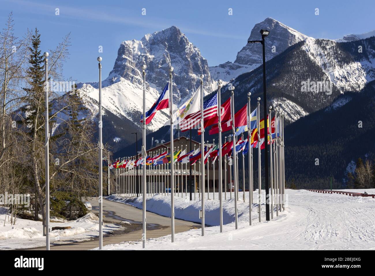 International Olympic Flags Canmore Alberta Nordic Centre Recreational Facility Center Canadian Rocky Mountain Peak Ski Banff National Park background Foto Stock