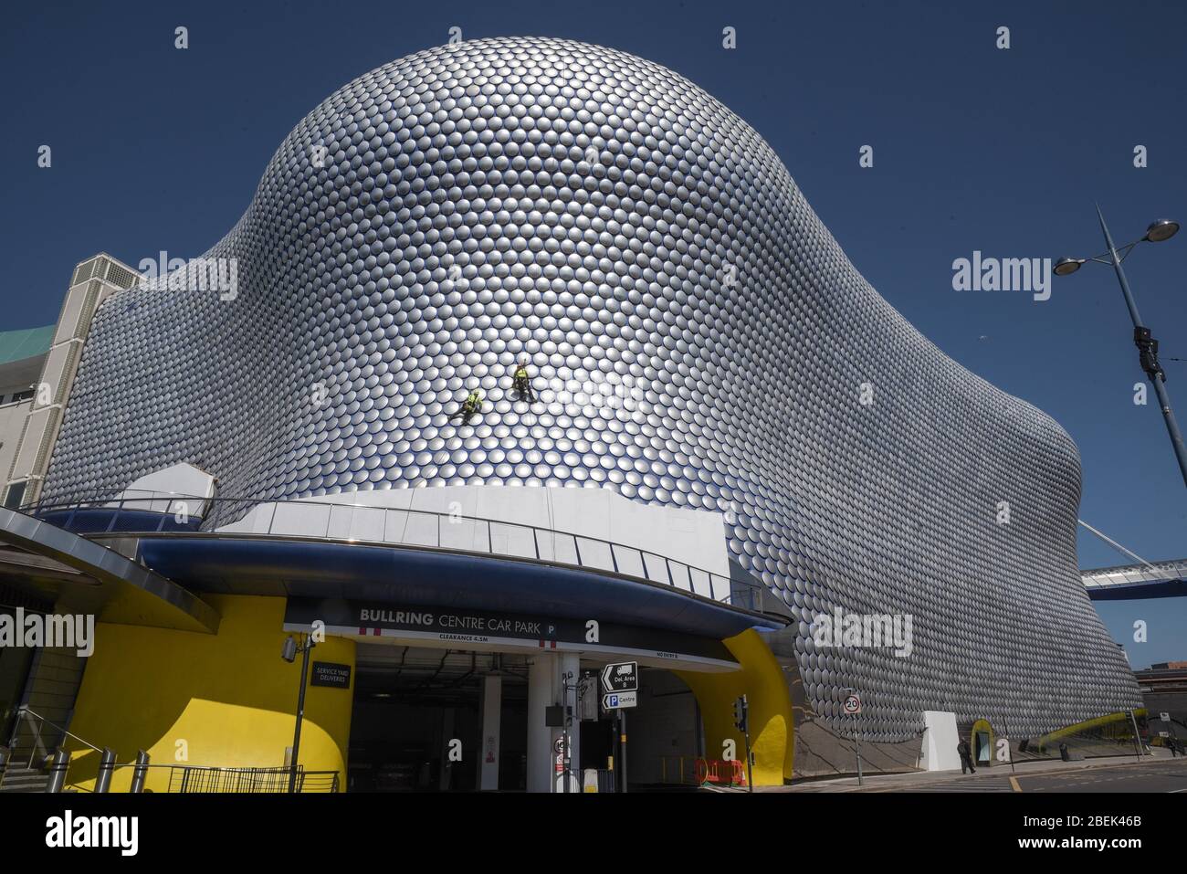 Birmingham, West Midlands, Regno Unito. 14 aprile 2020. Gli operai si scagliano lungo l'esterno del Selfridges nel centro di Birmingham per controllare se uno dei dischi è allentato. I lavoratori hanno utilizzato il blocco per lavorare senza causare gravi disagi ai pedoni sottostanti. Credito: Interrompi stampa Media/Alamy Live News Foto Stock