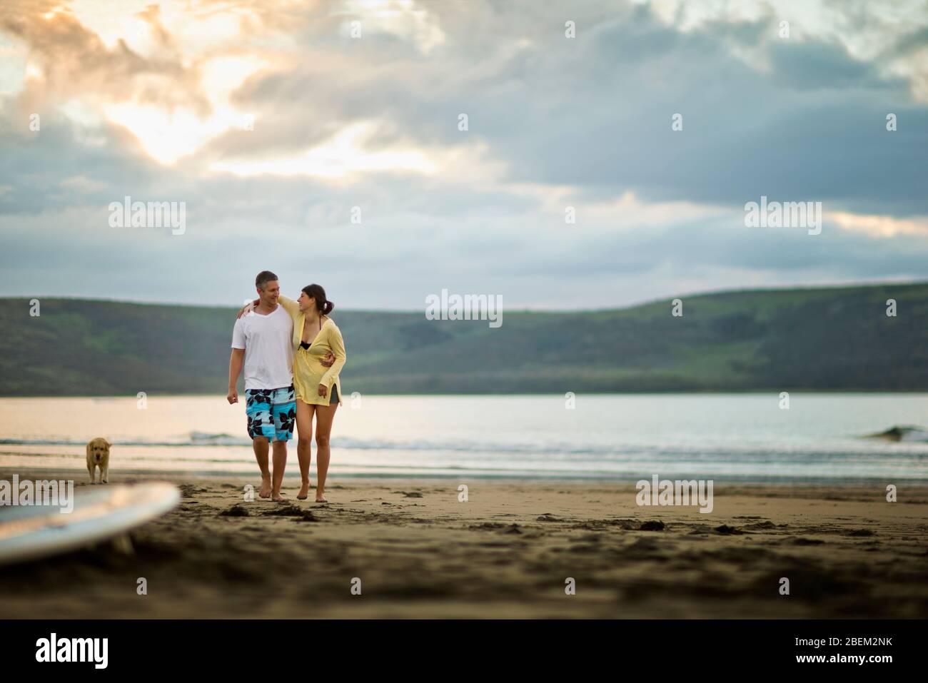 Coppia di adulti di media età che cammina insieme sulla spiaggia Foto Stock