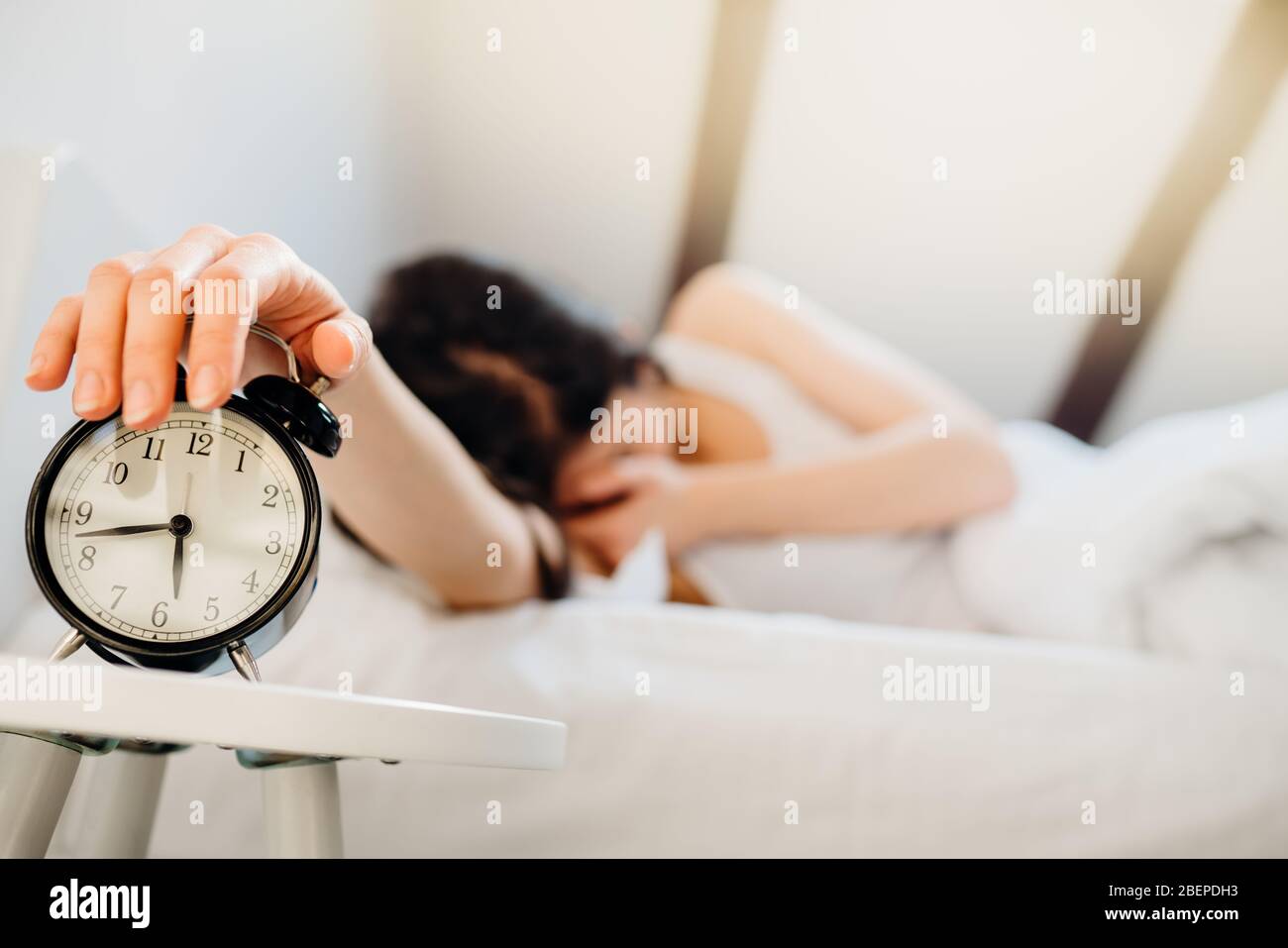 Sveglia squilling.Woman sveglia in prima mattina per work.ostruttive sonno apnea effects.Mental stress dormire depression.Melatonin deficiency.Narc Foto Stock