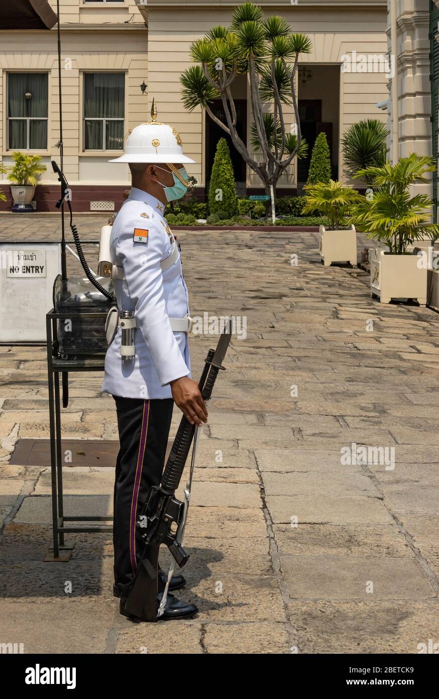 Bangkok, Thailandia - 29 febbraio 2020: Un soldato che custodisce il grande palazzo, tiene una pistola e indossa una maschera. Foto Stock