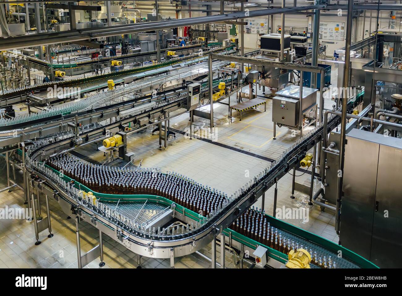 Moderni e automatizzati di imbottigliamento della birra linea di produzione. Le bottiglie di birra in movimento su nastro. Foto Stock