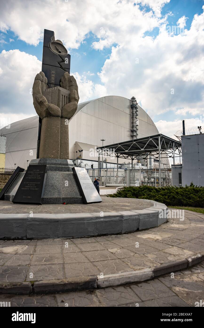 Centrale nucleare di Cernobyl con riparo e monumento in memoria di disastri. Regione di Kiev, Ucraina Foto Stock