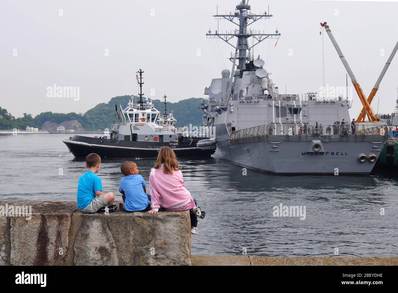 YOKOSUKA, Giappone (17 maggio 2012) i bambini di velisti assegnati alle visite-missile destroyer USS McCampbell (DDG 85) guarda il come la nave parte per una pattuglia del Pacifico occidentale. Foto Stock
