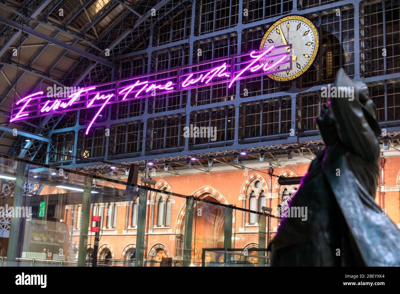 Statua di John Betjeman di Martin Jennings guarda 'i Want My Time with You' al neon arte luce di Tracy enim St. Pancras Station, Londra Foto Stock