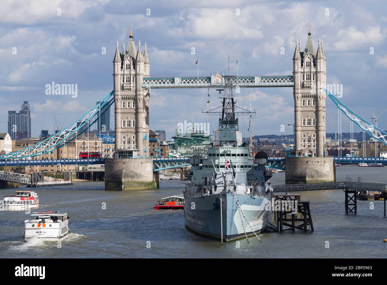 Tower Bridge e il permanentemente ormeggiato secondo guerra mondiale Cruiser HMS Belfast. Il Belfast è ora un museo galleggiante gestito dal museo imperiale della guerra. Foto Stock