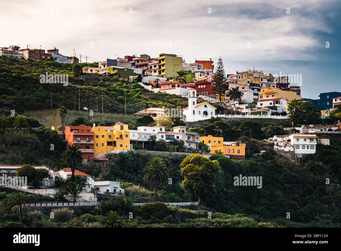 Case colorate in cima a una collina terrazzata vicino al villaggio di Icod de los Vinos, nel nord di Tenerife, Isole Canarie, Spagna in un pomeriggio invernale nuvoloso Foto Stock