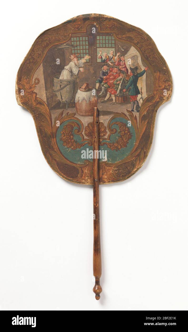 Schermata del telefono. Schermo con foglia di carta dipinta a mano e manico in legno tornito. Obverse: Scena interna rustica che mostra un uomo barbuto con una pentola sulla testa che emerge da un grande recipiente di cottura davanti ad un gruppo di uomini; due donne osservano dalla finestra. Foto Stock