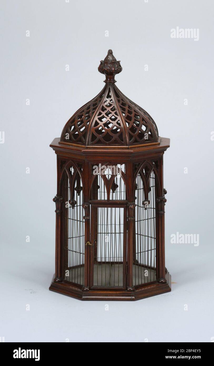 Gabbia di compleanno. Forma ottagonale di legno e filo metallico; archi di ogee che scaturisce da colonne raggruppate sugli otto angoli; un lato con porta a cerniera. Ogee cupolata con imbrificazione traforata e frondosa finiale. Fondo della lamiera. Due perches e un swing in interno. Foto Stock