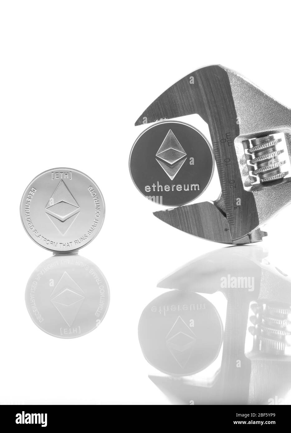 Ethereum sulla scrivania riflettente, primo piano. Denaro virtuale di criptovaluta. Exchange, anonimo. Bitcoin è una valuta di cassa web open source. Bianco retro gr Foto Stock