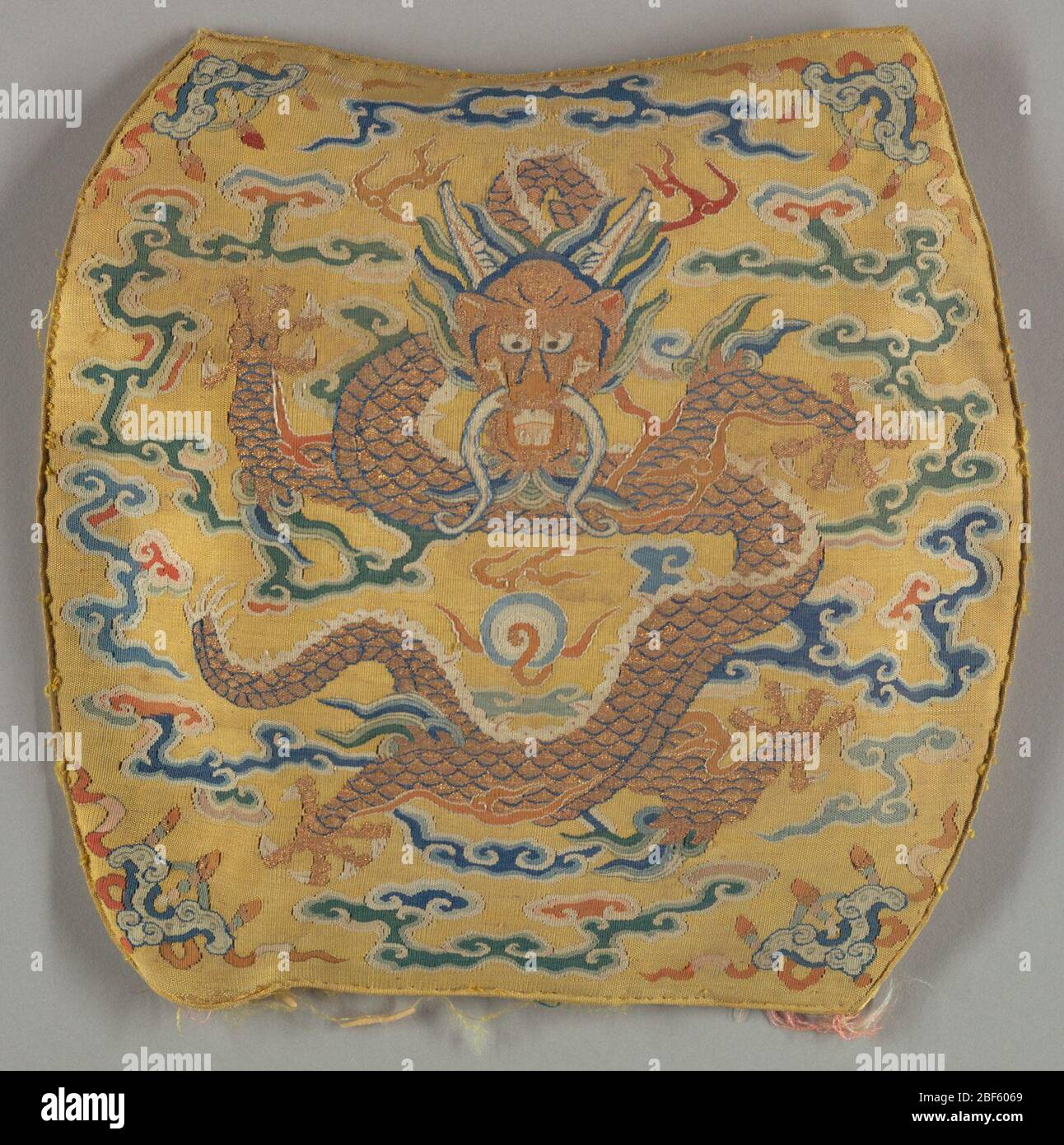Copricuscino. Quattro pezzi che, una volta assemblati, formerebbero un piccolo cuscino. Ogni pannello contiene un drago con fangs intorno a motivi nuvolari. Foto Stock