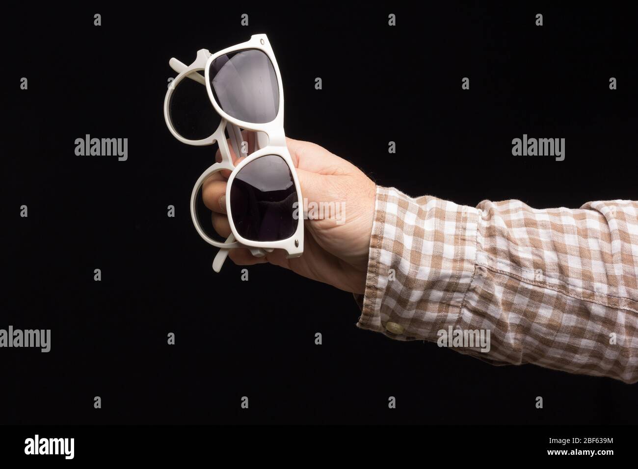 Salute visiva negli occhiali, occhiali da vista per correzione della  visione, occhiali colorati designer su sfondo nero. Lenti colorate nella  mano di un Foto stock - Alamy