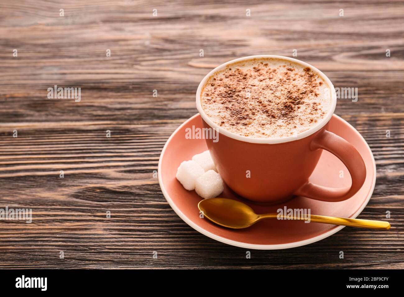 Tazza di cappuccino gustoso su sfondo di legno Foto Stock