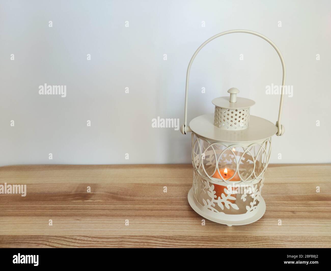 Lanterna vintage con una candela arancione sul tavolo con sfondo nero. Concetto - festa di Ramadan kareem. Foto d'archivio royalty free Foto Stock