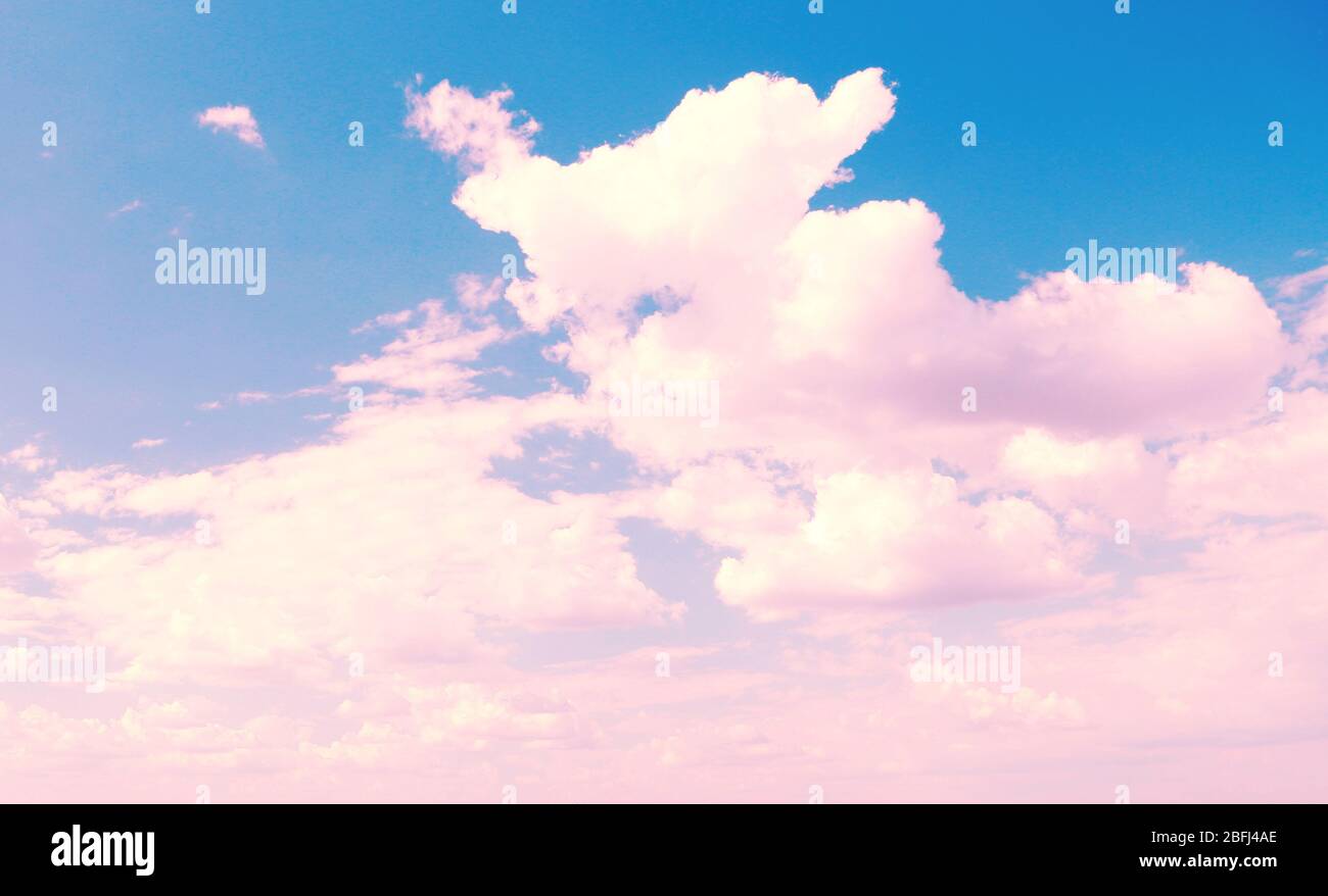 Blu cielo sfondo con nuvole rosa Foto stock - Alamy