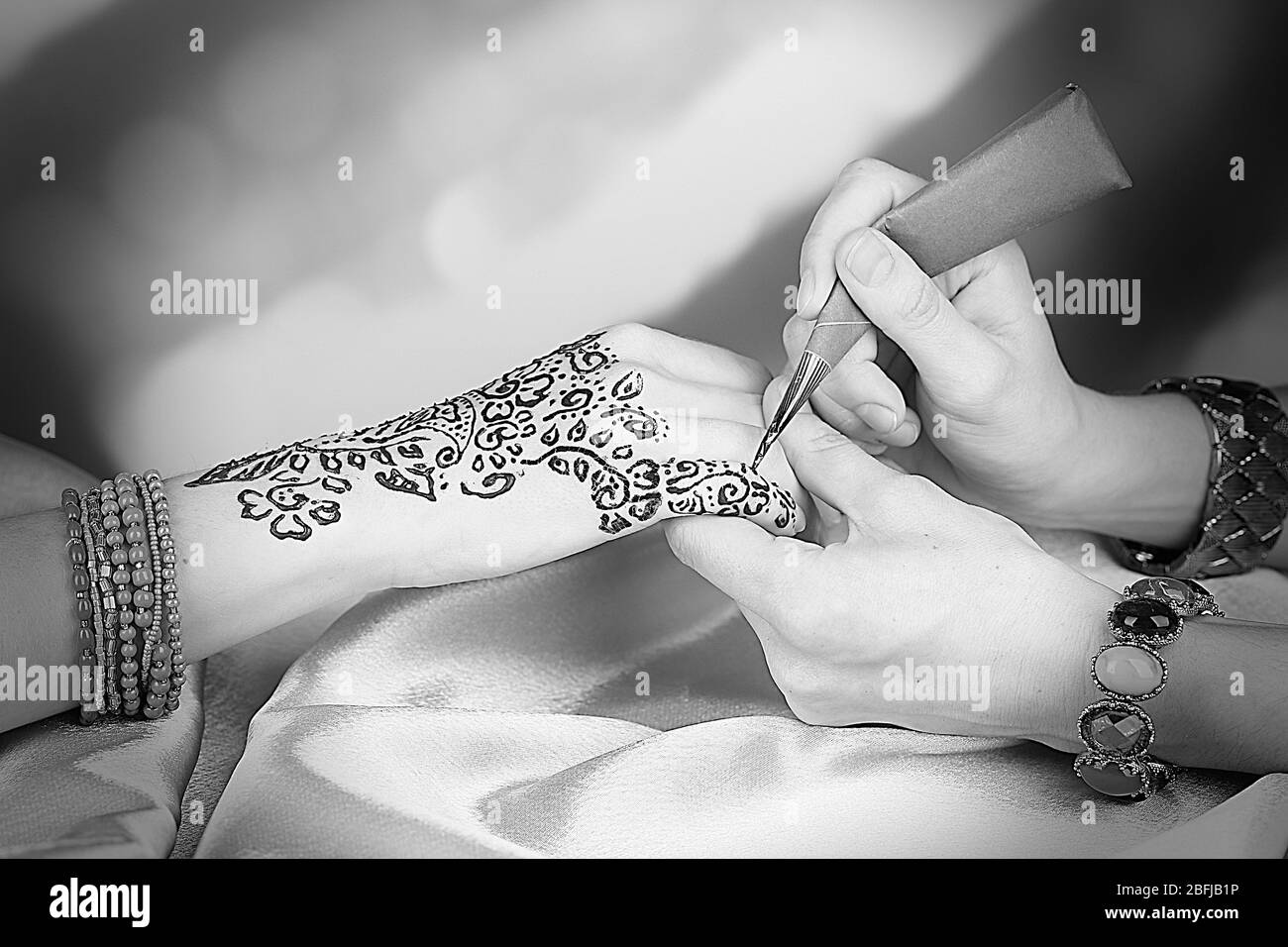 Il processo di applicazione della Mehndi sulla mano femminile, close up Foto Stock