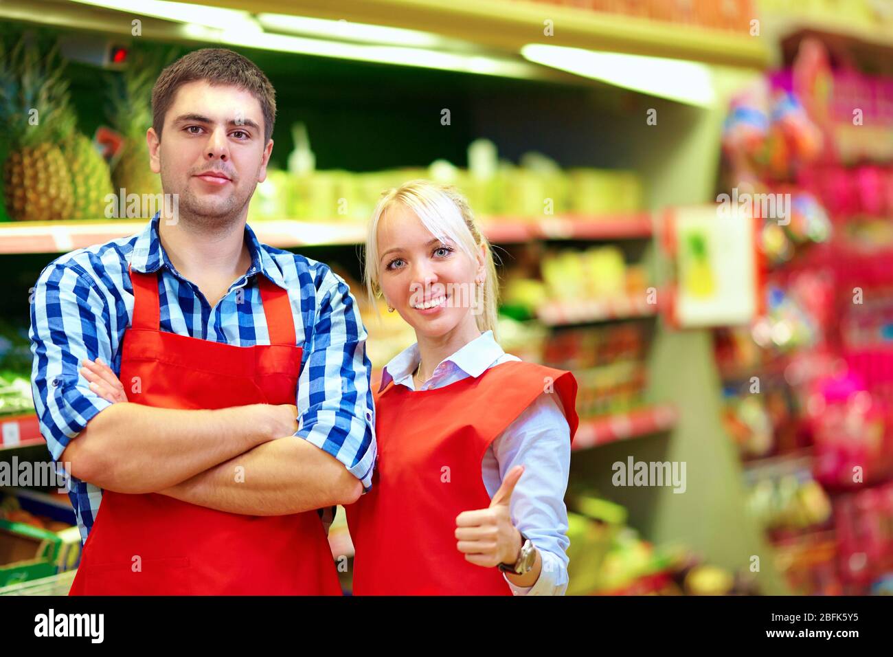 il personale della drogheria era sorridente e lavorava al supermercato Foto Stock