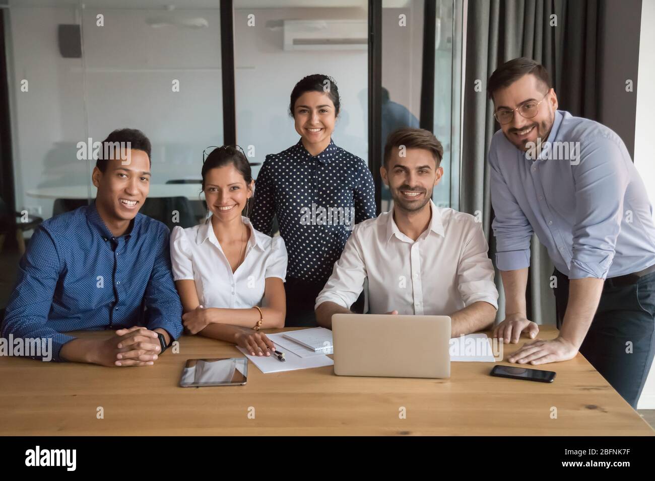 Membri di successo di un'azienda multietnica fotografati in ufficio Foto Stock