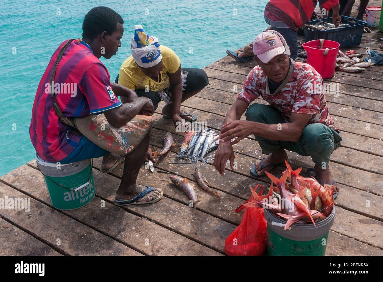 Santa Maria, Capo Verde - Dicembre 2011: Pescatore sul molo di taglio e vendita di pesce Foto Stock