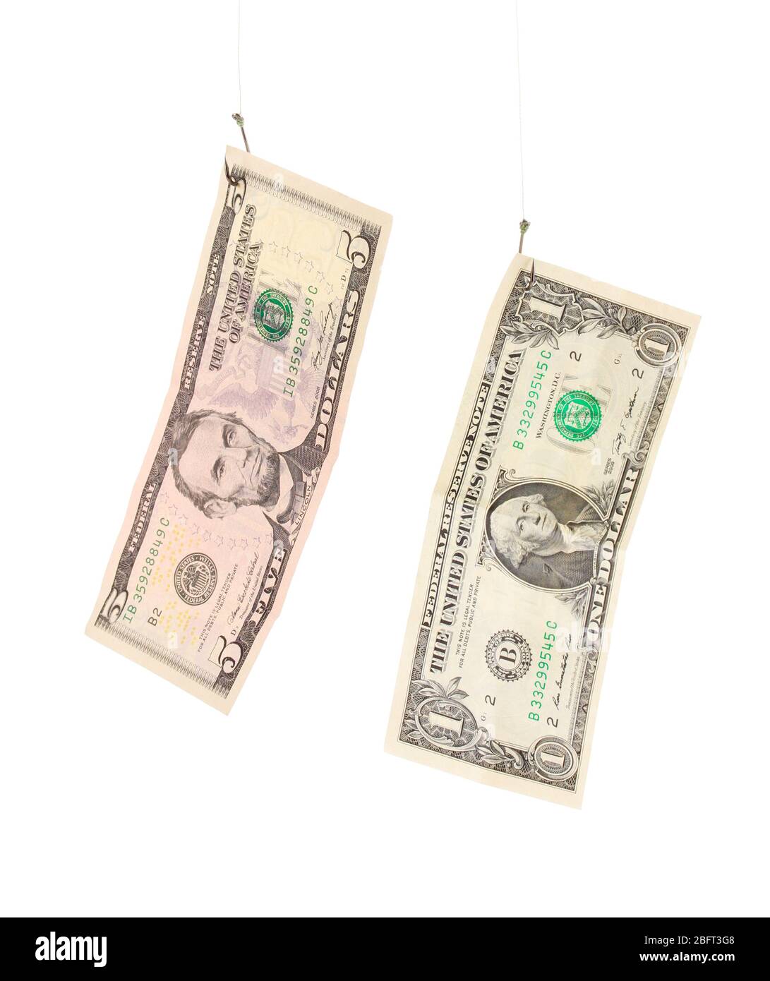 Dollari su ganci di pesca isolati su bianco Foto Stock