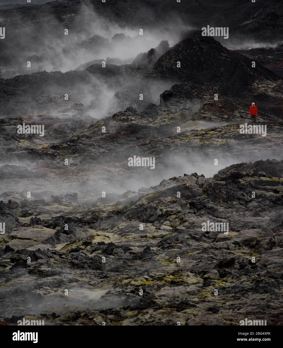 Donna escursioni attraverso il campo di lava al vulcano Krafla Foto Stock
