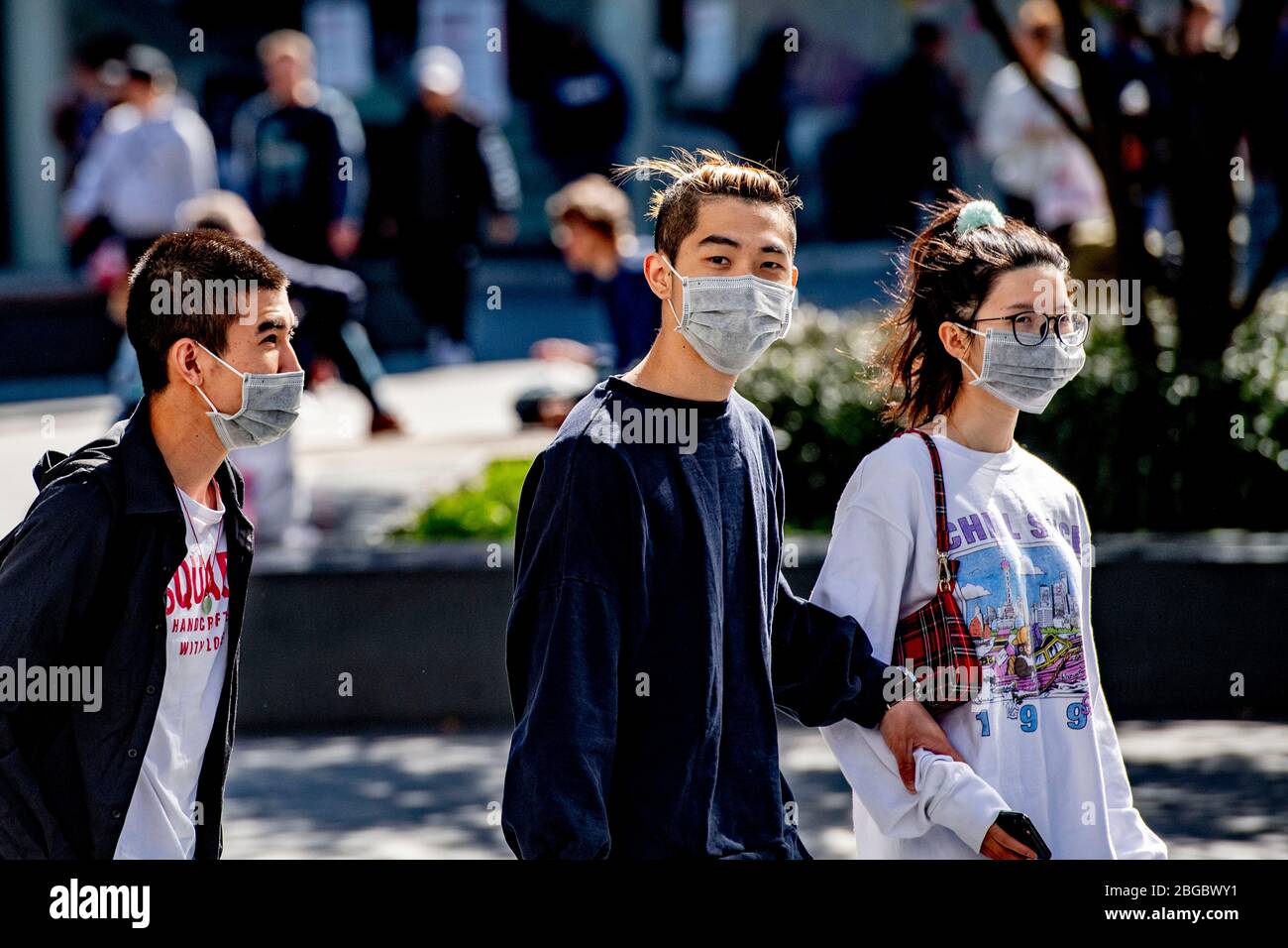 Le persone che indossano maschere facciali come misura preventiva contro la diffusione del coronavirus a piedi sulla strada.indossare maschere facciali è diventato popolare perché è una delle misure preventive più applicate contro la malattia del covid-19. Foto Stock