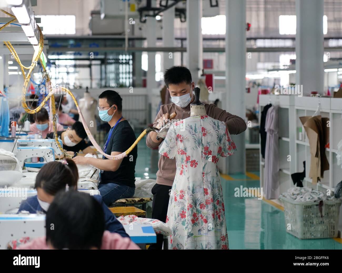 Xingtai, provincia cinese di Hebei. 21 Apr 2020. La gente lavora in una fabbrica di abbigliamento a Nangong City, nella provincia di Hebei, nel nord della Cina, il 21 aprile 2020. Le imprese di Nangong hanno intensificato la produzione da aprile per digerire il ritardo degli ordini dovuto all'epidemia di COVID-19. Credit: MU Yu/Xinhua/Alamy Live News Foto Stock