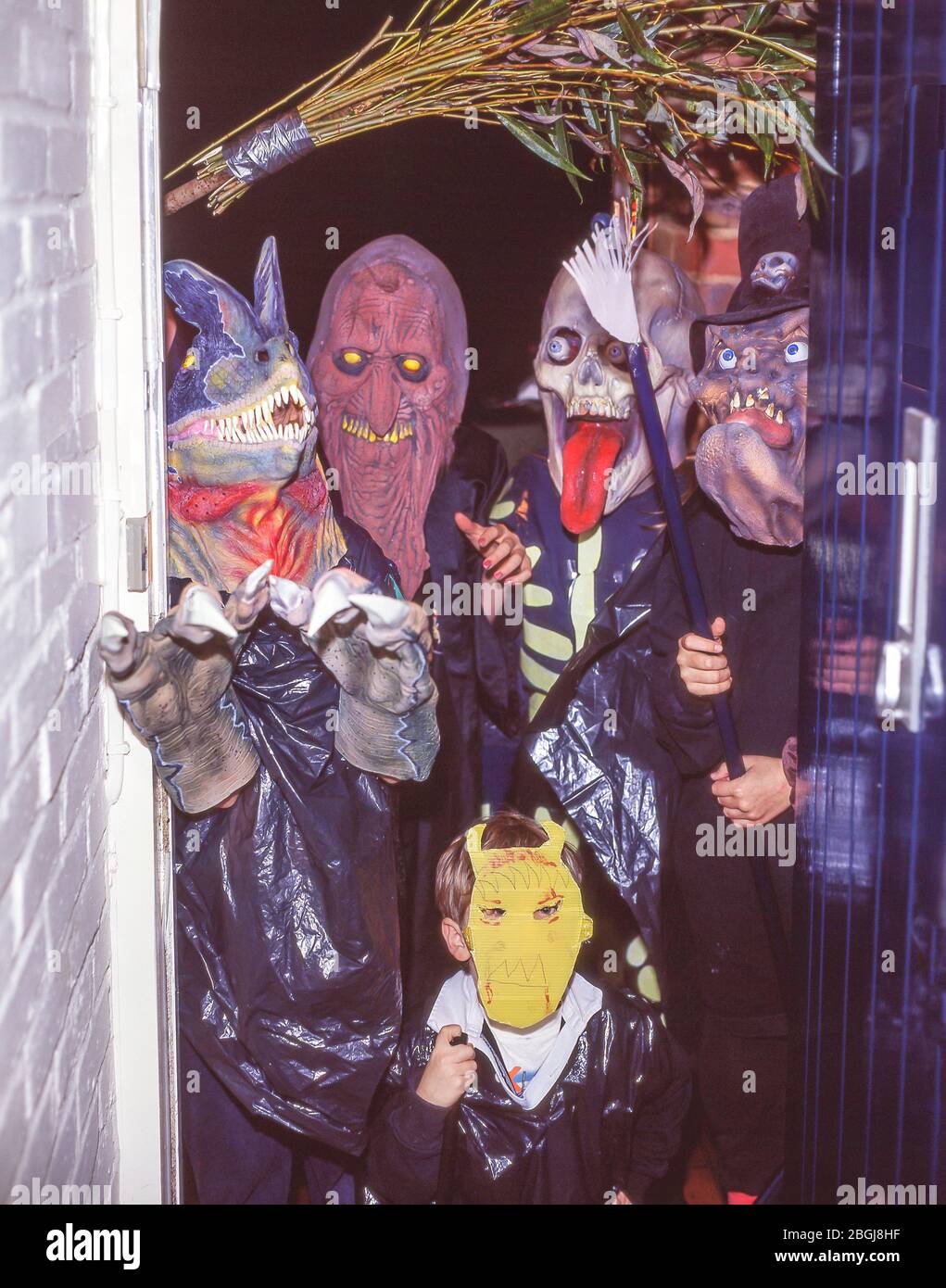 Bambini 'trick-or-treating' in doorway, Ascot, Berkshire, Regno Unito Foto Stock