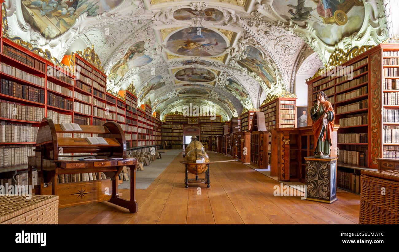 Una vista lungo la famosa Sala lettura nella Biblioteca Strahov, Praga. Antiche tombe fiancheggiano le pareti sotto il soffitto, dai dettagli ornatissimi. Foto Stock