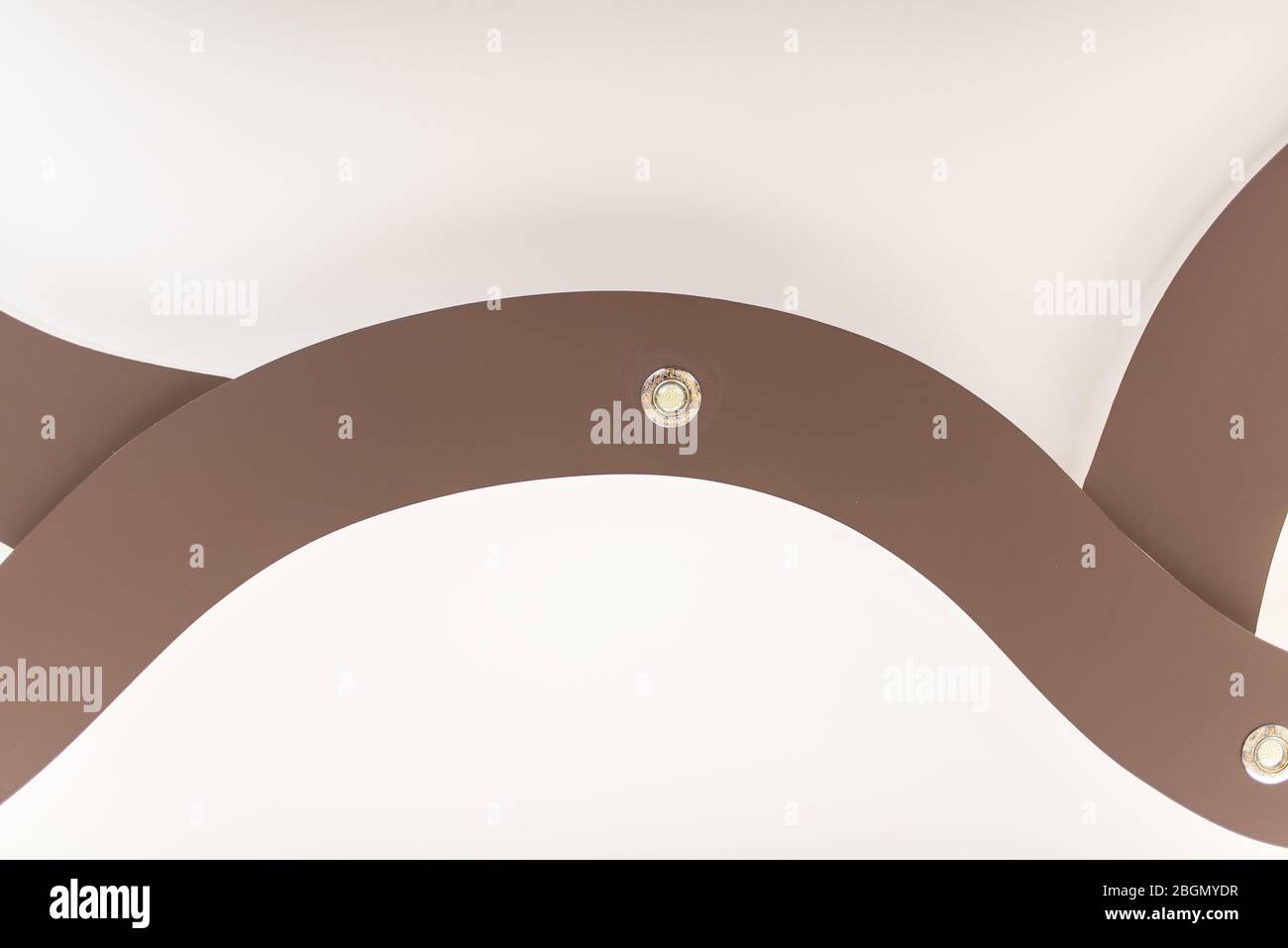 Soffitto stretch di colore marrone chiaro con lampade. Foto Stock