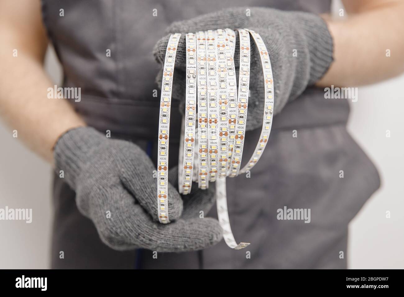 Elettricista che installa il nastro di montaggio striscia LED illuminazione decorativa Foto Stock